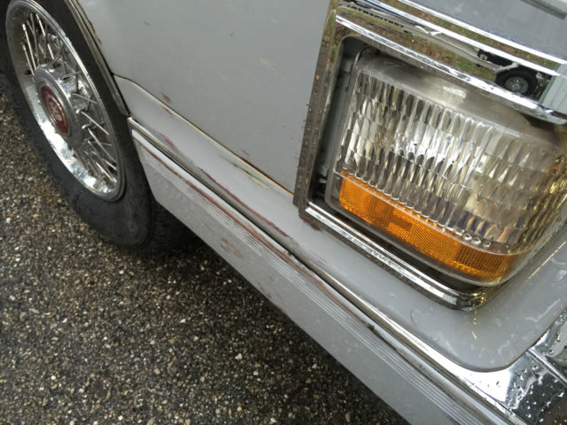 1990 light grey Cadillac Brougham Sedan