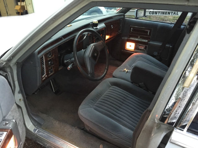 1990 light grey Cadillac Brougham Sedan