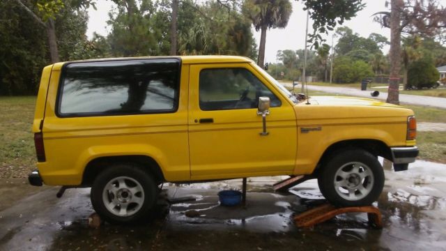1990 Yellow Ford Bronco SUV