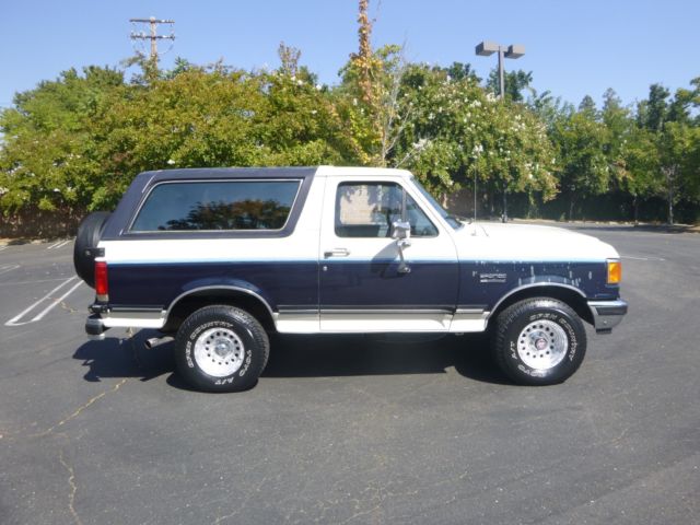 1990 white/blue Ford Bronco