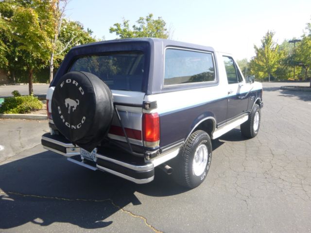 1990 white/blue Ford Bronco