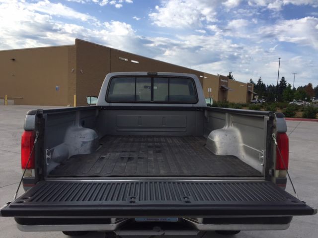 1990 grey Ford F-250 single cab pick up