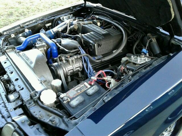 1990 Mercedes met grey Ford Mustang Coupe