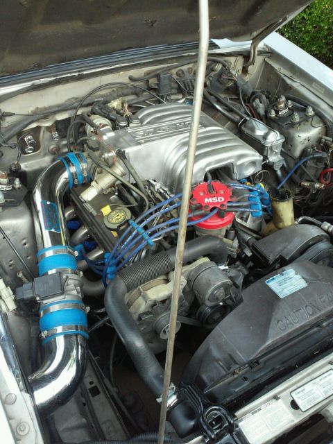 1990 gray Ford Mustang Hatchback