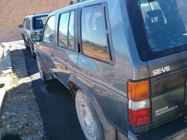 1991 blue/gray Nissan Pathfinder SUV