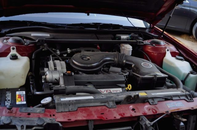 1991 Red Cadillac DeVille Sedan