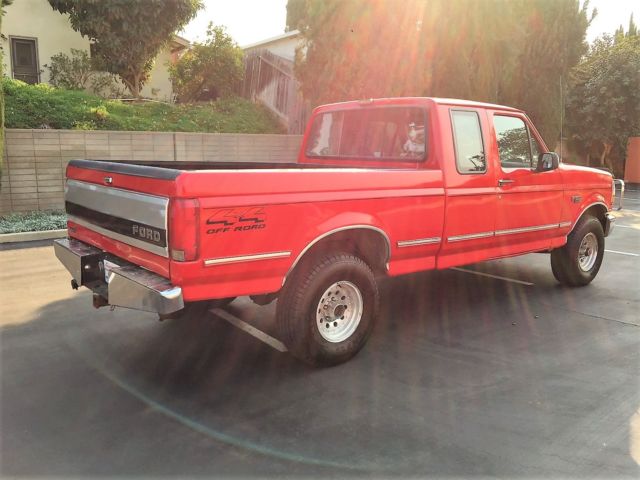 1993 red Ford F-150 Extended Cab Pickup
