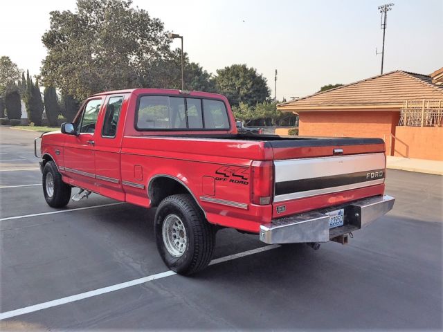 1993 red Ford F-150 Extended Cab Pickup