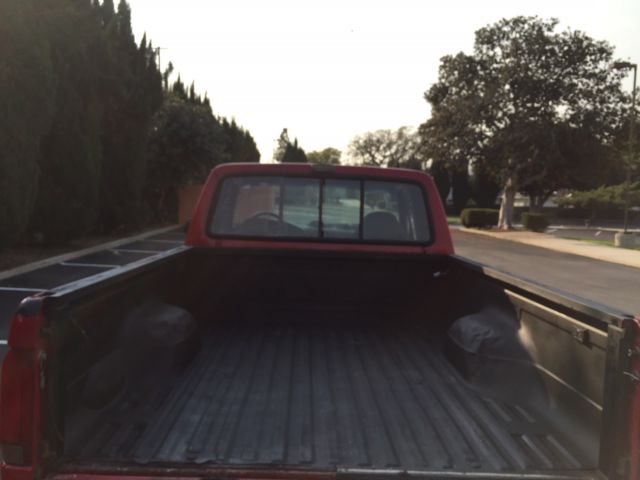 1993 red Ford F-150 Extended Cab Pickup