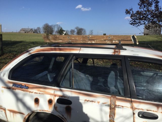 1993 White with rust Toyota Corolla Wagon