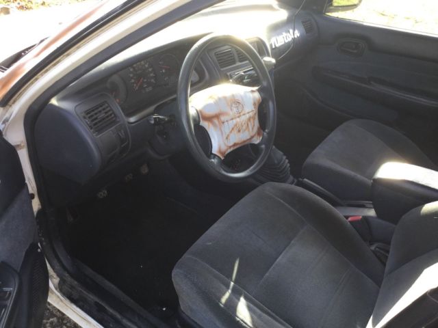 1993 White with rust Toyota Corolla Wagon