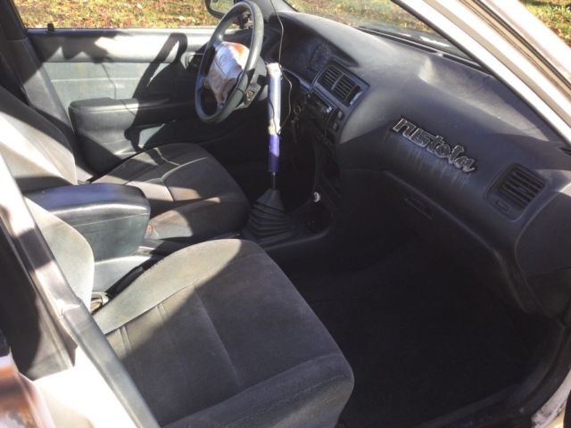 1993 White with rust Toyota Corolla Wagon