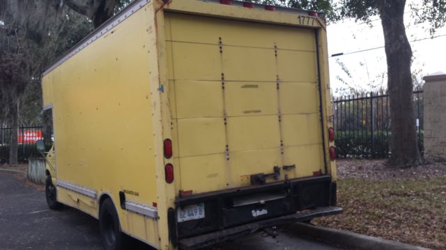 1994 Yellow Ford E-Series Van Box with overhead cabin space