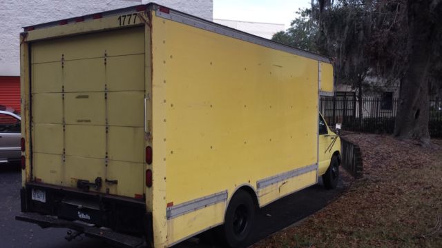 1994 Yellow Ford E-Series Van Box with overhead cabin space