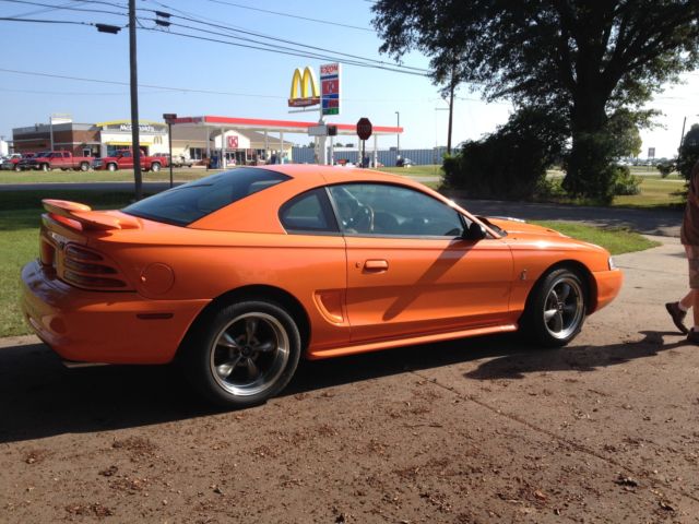 1994 orange Ford Mustang 2 door
