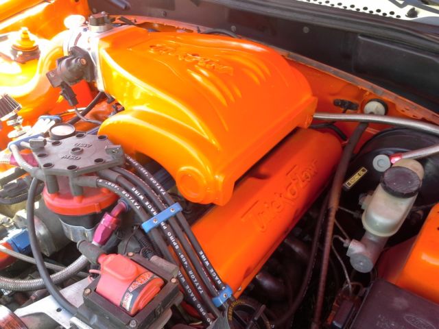 1994 orange Ford Mustang 2 door