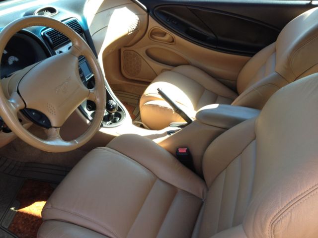 1994 orange Ford Mustang 2 door