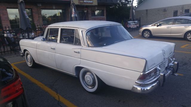 1965 White Mercedes-Benz 200-Series Sedan