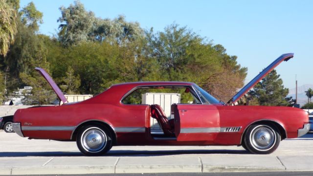 1966 Burgundy Oldsmobile Starfire Coupe