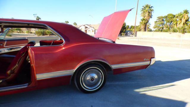 1966 Burgundy Oldsmobile Starfire Coupe