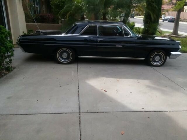 1962 Black (originally white but you can't tell) Pontiac Grand Prix Coupe