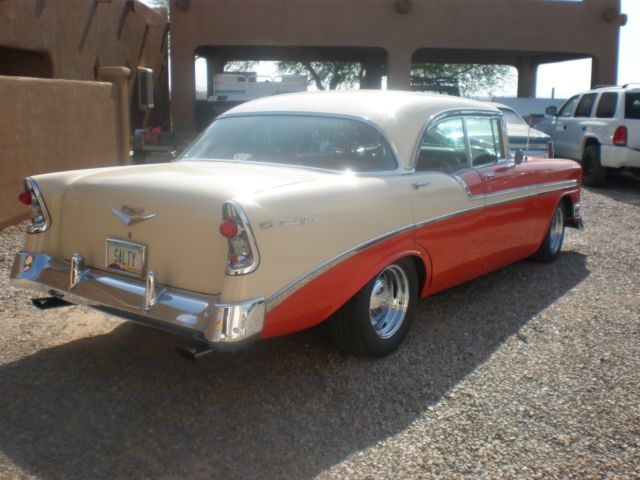 1956 red and white Chevrolet Bel Air/150/210 4 dr hard top