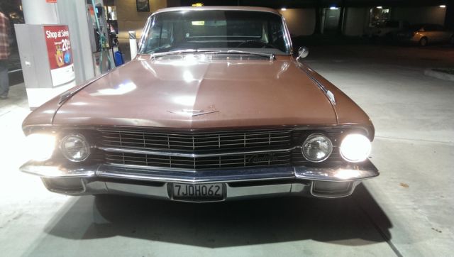 1962 Burgundy Cadillac Fleetwood Sedan