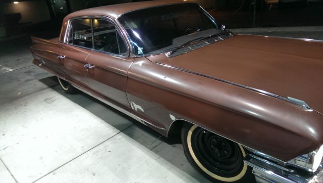 1962 Burgundy Cadillac Fleetwood Sedan