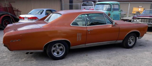1967 bronze Pontiac Le Mans Coupe