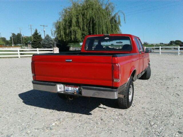 1993 Red and Black Ford F-150 Extended Cab Pickup