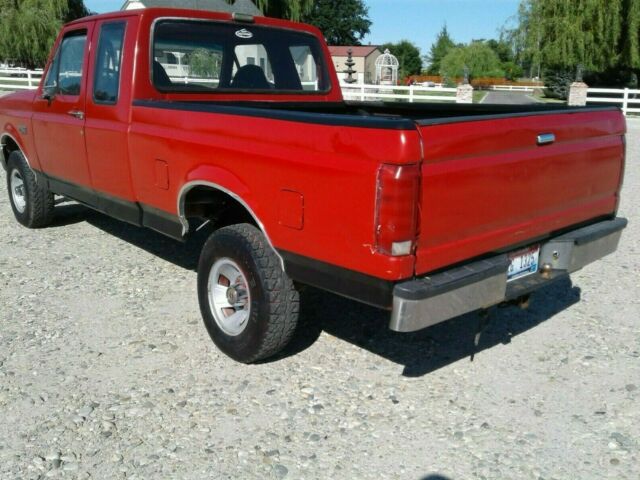 1993 Red and Black Ford F-150 Extended Cab Pickup