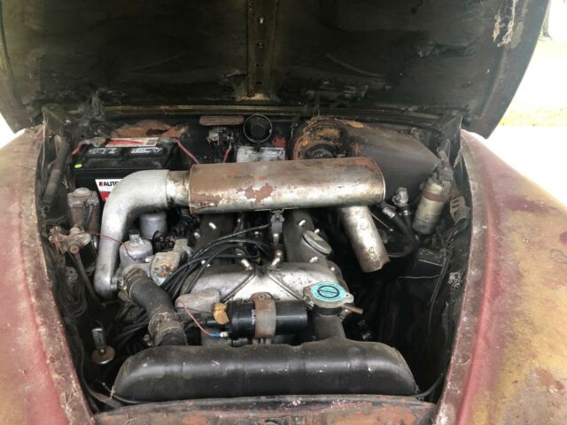 1965 red Jaguar 3.8 Sedan