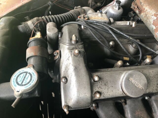 1965 red Jaguar 3.8 Sedan