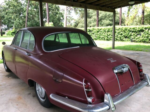 1965 red Jaguar 3.8 Sedan