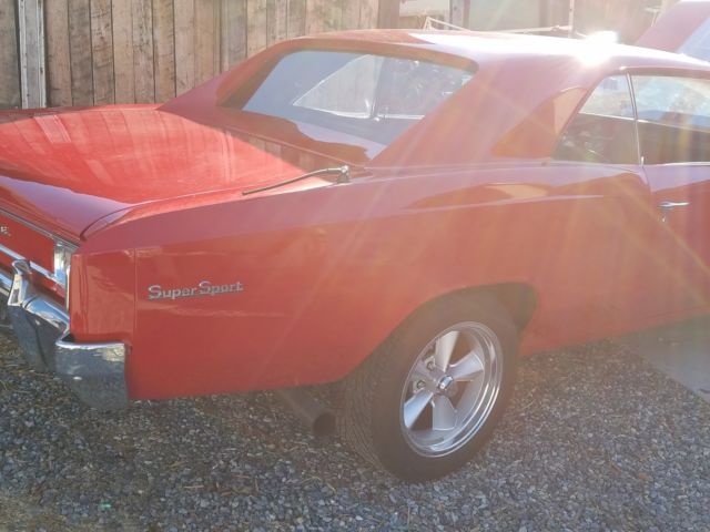 1966 red Chevrolet Chevelle Coupe