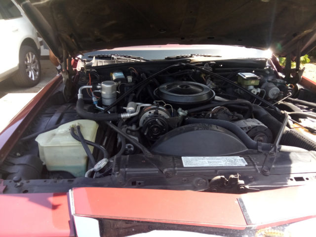 1987 Red Cadillac Brougham Sedan