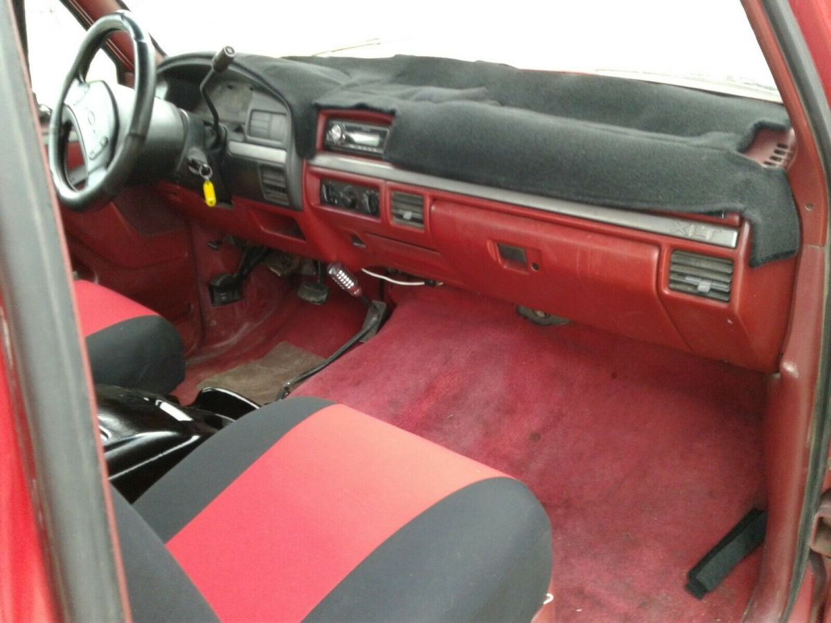 1993 Red and Black Ford F-150 Extended Cab Pickup, seats five.