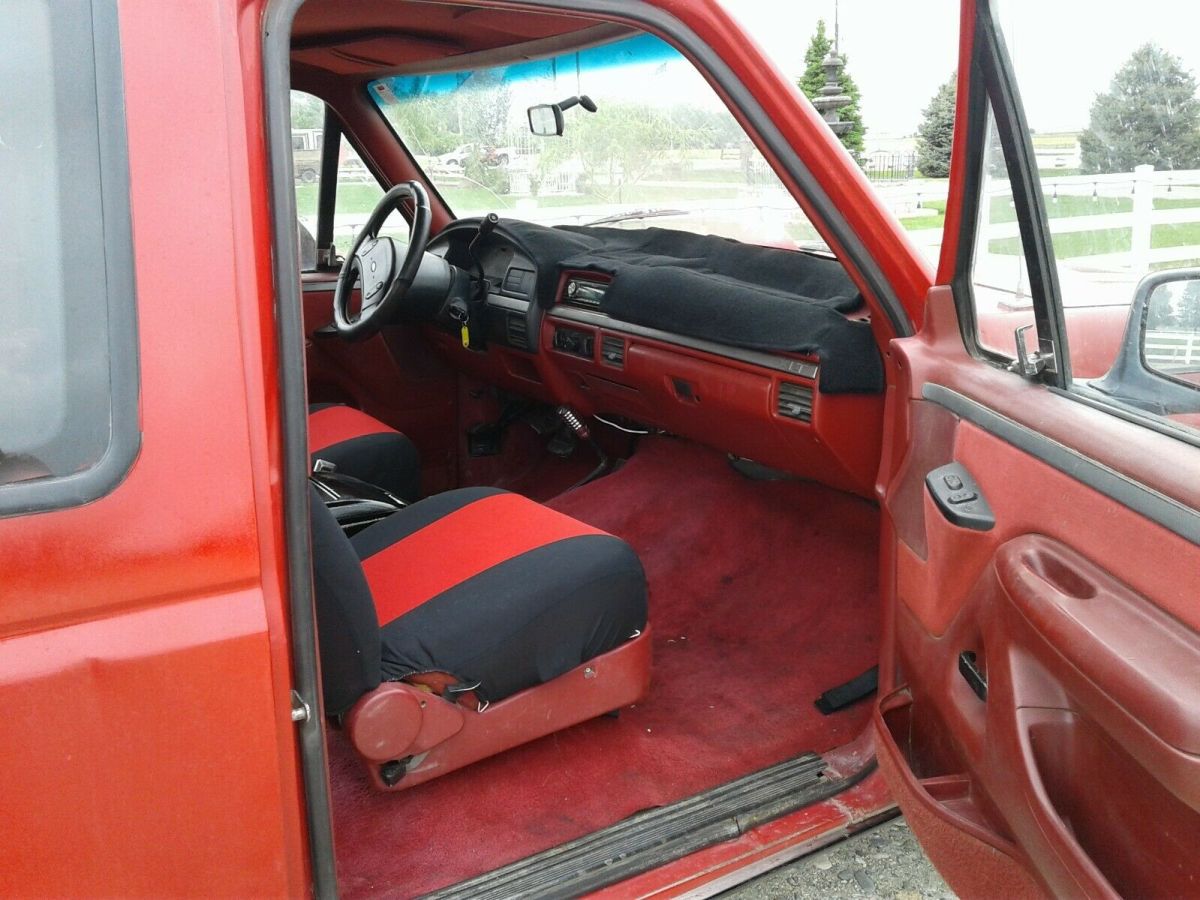 1993 Red and Black Ford F-150 Extended Cab Pickup, seats five.