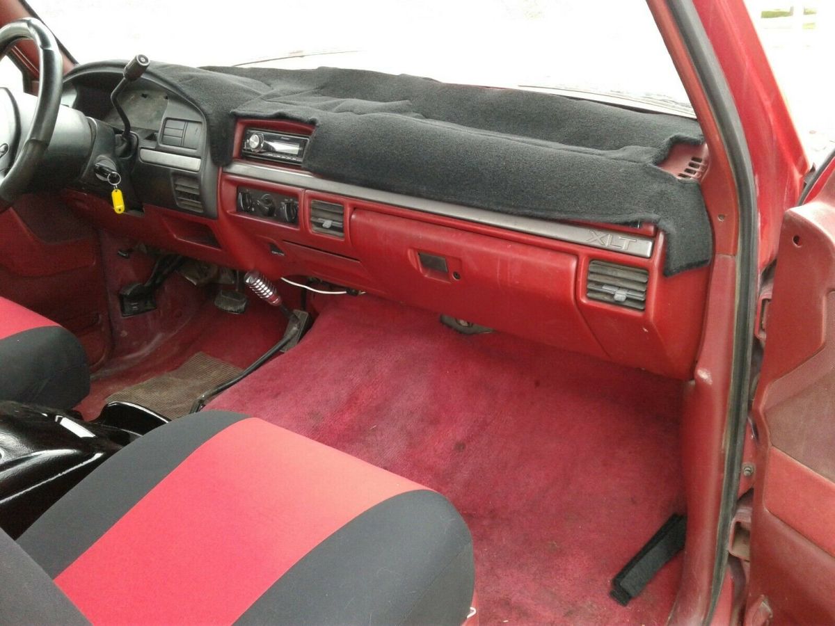 1993 Red and Black Ford F-150 Extended Cab Pickup, seats five.