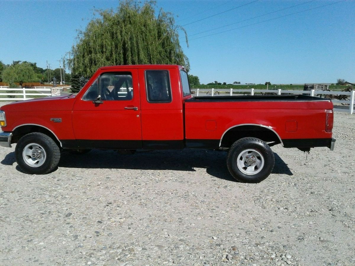 1993 Red and Black Ford F-150 Extended Cab Pickup, seats five.