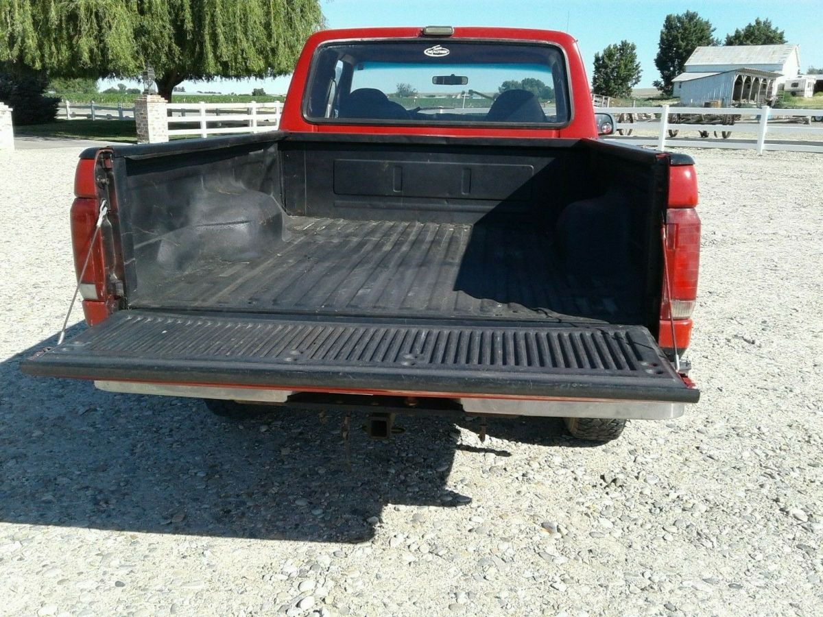 1993 Red and Black Ford F-150 Extended Cab Pickup, seats five.
