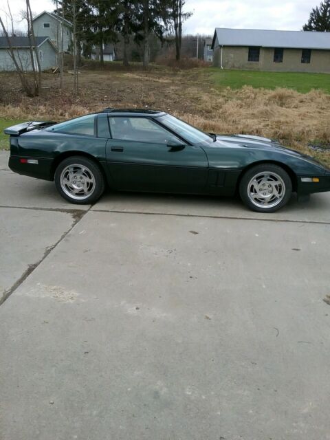 1990 dark green metallic Chevrolet Corvette Coupe