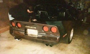 1990 dark green metallic Chevrolet Corvette Coupe