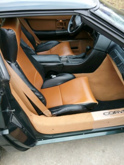 1990 dark green metallic Chevrolet Corvette Coupe