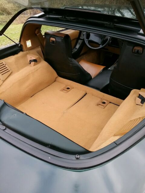 1990 dark green metallic Chevrolet Corvette Coupe