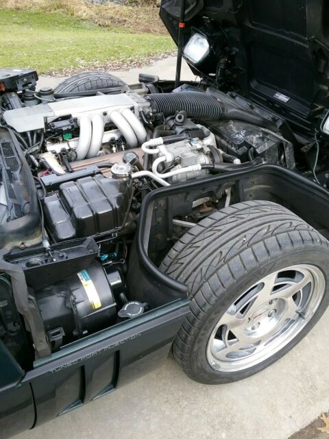 1990 dark green metallic Chevrolet Corvette Coupe