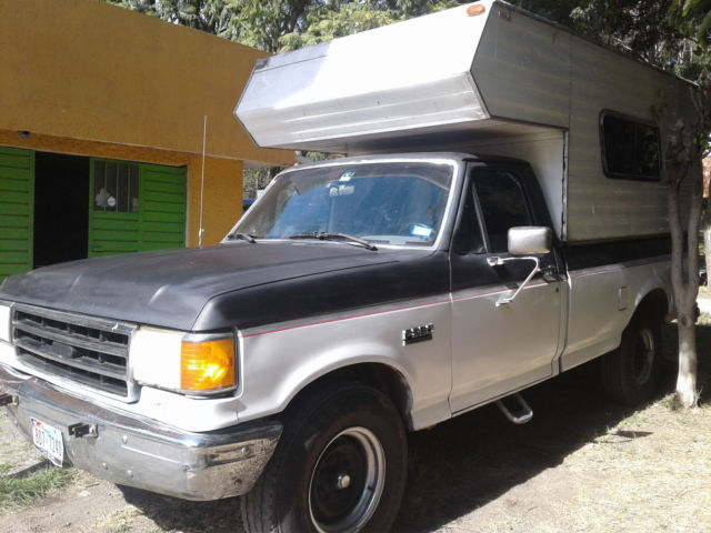 1990 black and white Ford F-250 pickup
