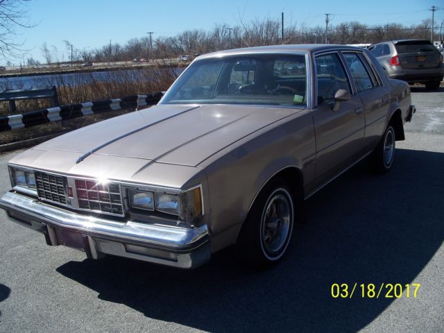 1984 lt.brown Oldsmobile Cutlass Sedan