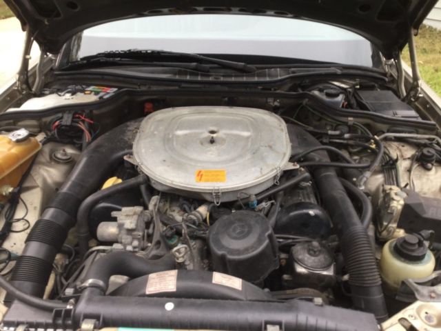 1987 gold Mercedes-Benz 500-Series SEDAN