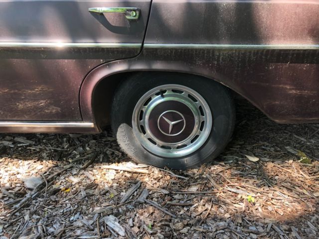 1973 maroon Mercedes-Benz 200-Series Sedan